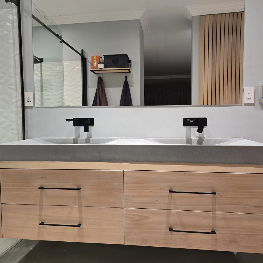 Solid Saligna unit with custom concrete basins by DSK Woodwork